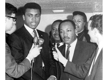 FILE - In this March 29, 1967, file photo, heavyweight champion Muhammad Ali, center left, and Dr. Martin Luther King speak to reporters. Ali, the magnificent heavyweight champion whose fast fists and irrepressible personality transcended sports and captivated the world, has died according to a statement released by his family Friday, June 3, 2016. He was 74. (AP Photo/File) ORG XMIT: NY218