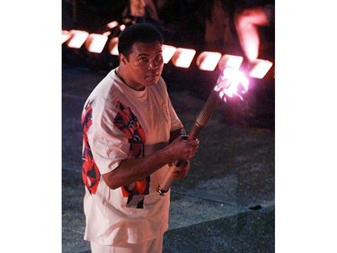 FILE - In this July 19, 1996, file photo, Muhammad Ali watches as the flame climbs up to the Olympic torch during the opening ceremonies of the Summer Olympics, in Atlanta. Ali, the magnificent heavyweight champion whose fast fists and irrepressible personality transcended sports and captivated the world, has died according to a statement released by his family Friday, June 3, 2016. He was 74. (AP Photo/Doug Mills, File) ORG XMIT: NY217