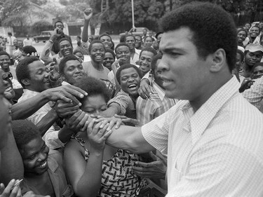 FILE - In this Sept. 17, 1974, file photo, Muhammad Ali is greeted in downtown Kinshasa, Zaire. Ali is in Zaire to fight George Foreman. Ali, the magnificent heavyweight champion whose fast fists and irrepressible personality transcended sports and captivated the world, has died according to a statement released by his family Friday, June 3, 2016. He was 74. (AP Photo) ORG XMIT: NY209