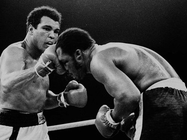 FILE - In this Oct. 1, 1975, file photo, Muhammad Ali's throws a right at Joe Frazier in the 13th round in their title bout in Manila, Philippines. Ali, the magnificent heavyweight champion whose fast fists and irrepressible personality transcended sports and captivated the world, has died according to a statement released by his family Friday, June 3, 2016. He was 74. (AP Photo/FILE) ORG XMIT: NY208