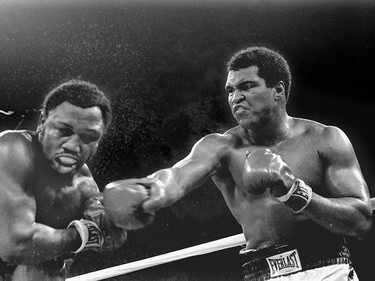 FILE - In this Oct. 1, 1975, file photo, spray flies from the head of challenger Joe Frazier as heavyweight champion Muhammad Ali connects with a right in the ninth round of their title fight in Manila, Philippines. Ali, the magnificent heavyweight champion whose fast fists and irrepressible personality transcended sports and captivated the world, has died according to a statement released by his family Friday, June 3, 2016. He was 74. (AP Photo/Mitsunori Chigita, File) ORG XMIT: NY207