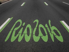 The logo of the Rio 2016 Olympic Games painted in green to distinguish it as the special lane for the games, on a road pedestrianized on Sundays, on June 26, 2016, in Rio de Janeiro, Brazil.