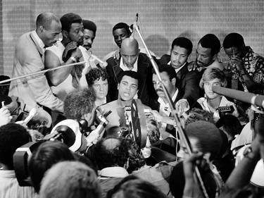 TO GO WITH AFP STORIES In this photo taken on October 30, 1974 shows US boxing heavyweight champion Muhammad Ali (C) (born Cassius Clay) during a press conference after the heavyweight world championship in Kinshasa. On October 30, 1974 Muhammad Ali knocked out George Foreman in a clash of titans known as the "Rumble in the Jungle", watched by 60 000 people in the stadium in Kinshasa and millions elsewhere AFP PHOTO        (Photo credit should read STR/AFP/Getty Images) ORG XMIT: BOX10      Muhammad Ali options ORG XMIT: POS1606031703380283