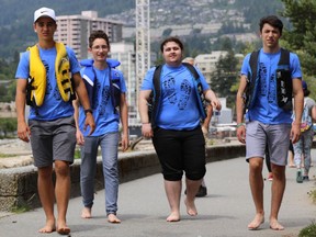 The walk was the idea of Sentinel Secondary students Yigal Bruk, left, Marcelo Gonzales, Kameron Karimi and Manuel Rojas. — Laura Neubert photo