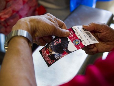VANCOUVER,BC:JUNE 20, 2016 -- An usher rips the ticket of a fan at Nat Bailey Stadium as they enter the stadium for opening night of Vancouver Canadians baseball as they take on the Everett AquaSox in Vancouver, BC, June, 20, 2016.