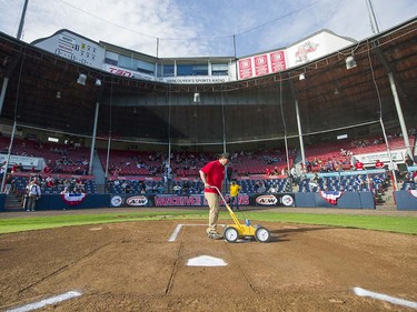 VANCOUVER,BC:JUNE 20, 2016 -- A member of the grounds crew paints in the batter's box at Nat Bailey Stadium prior to the home opening night of Northwest League baseball between the Vancouver Canadians and the Everett AquaSox in Vancouver, BC, June, 20, 2016.