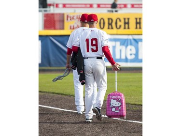 VANCOUVER,BC:JUNE 20, 2016 -- Rookie relief pitcher Grayson Huffman of the Vancouver Canadians carries out Hello Kitty suitcase containing bullpen candy prior to opening night action of Northwest League baseball between the Canadians and the Everett AquaSox in Vancouver, BC, June, 20, 2016.