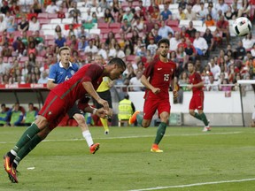 In this June 8, 2016, file photo, Portugal's Cristiano Ronaldo heads the ball to score against Estonia during a friendly soccer match in Lisbon, Portugal.