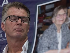 Price Carter, son of Lee Carter (in photo in foreground) pauses for a moment during a news conference at British Columbia Civil Liberties in Vancouver, B.C., Monday, June, 6, 2016. Price and his sister Kay Carter were speaking on the Supreme Court of Canada's death with dignity ruling.