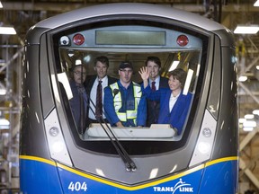 Prime Minister Justin Trudeau arrives on a sky train with British Columbia Premier Christy Clark and Vancouver City Mayor Gregor Robertson at a sky train garage in Burnaby, B.C. Thursday, June, 16, 2016. The prime minister made an announcement regarding transit funding for the province.
