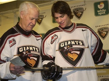 Hockey legend Gordie Howe (left) offers a few stick tips to Vancouver Giants draft prospect Gilbert Brule (right) shortly after the official team photo session at the home of the WHL team, the Pacific Coliseum in Vancouver February 17, 2003.