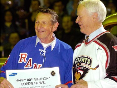 Wayne Gretzky's father Walter Gretzky (left) wishes Gordie Howe (right) a happy 80th birthday prior to the Vancouver Giants final regular season home game at the Pacific Coliseum March 16, 2008.