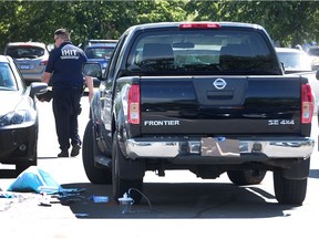 A truck with bullet holes in the side sits in the parking lot of Coppersmith Place in Richmond, BC., June 5, 2016. A man was shot and later died in hospital following the incident on Saturday evening.