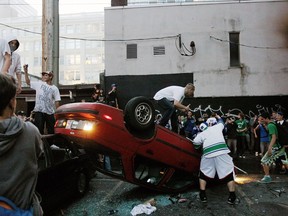 People flip a vehicle on June 15, 2011 in Vancouver, Canada. Vancouver broke out in riots after their hockey team the Vancouver Canucks lost in Game Seven of the Stanley Cup Finals.