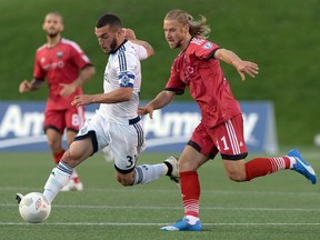 Vancouver Whitecaps' Russell Teibert keeps the ball from Ottawa Fury FC's Mozzi Gyorio, right, during the first half of Amway Canadian championship semi-final soccer action in Ottawa on Wednesday, June 1, 2016.