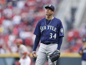 Felix Hernandez of the Seattle Mariners reacts after walking a batter in the fifth inning of their Major League Baseball game against the Cincinnati Reds at Great American Ball Park on May 21, 2016 in Cincinnati.