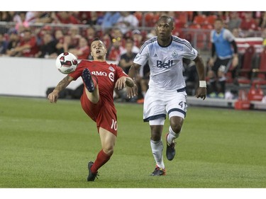 Toronto FC's Sebastian Giovinco (10) brings the ball down as Vancouver Whitecaps' Kendall Waston defends during second half Canadian Cup action in Toronto on Tuesday June 21, 2016.