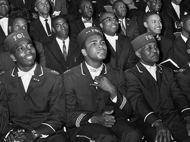 ADVANCE FOR USE SUNDAY, FEB. 23, 2014 AND THEREAFTER - FILE - In this Feb. 28, 1966 file photo, Muhammad Ali listens to Elijah Muhammad as he speaks to other black Muslims in Chicago. (AP Photo/Paul Cannon) ORG XMIT: NY354