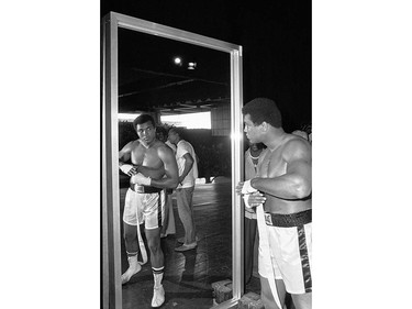 ADVANCE FOR USE SUNDAY, FEB. 23, 2014 AND THEREAFTER - FILE - In this Sept. 29, 1975 file photo, Muhammad Ali, world heavyweight boxing champion, looks at himself in a mirror during a training session in Manila, Philippines before his Oct. 1 fight against Joe Frazier. (AP Photo) ORG XMIT: POS2016060317075553      Muhammad Ali options ORG XMIT: POS1606031709490336