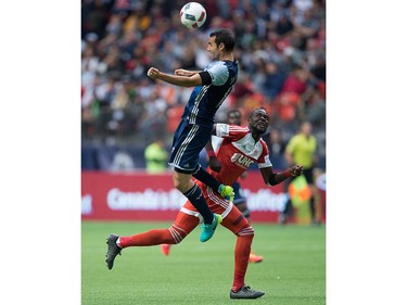 Vancouver Whitecaps' Andrew Jacobson, front, gets his head on the ball above New England Revolution's Kei Kamara during first half MLS soccer action in Vancouver, B.C., on Saturday June 18, 2016. THE CANADIAN PRESS/Darryl Dyck ORG XMIT: VCRD105