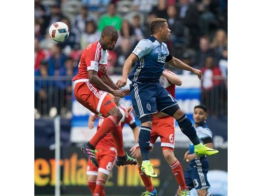 New England Revolution's Jose Goncalves, left, and Vancouver Whitecaps' Erik Hurtado vie for the ball during first half MLS soccer action in Vancouver, B.C., on Saturday June 18, 2016. THE CANADIAN PRESS/Darryl Dyck ORG XMIT: VCRD110