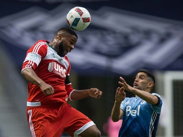 New England Revolution's Andrew Farrell, left, gets his head on the ball above Vancouver Whitecaps' Matias Laba during first half MLS soccer action in Vancouver, B.C., on Saturday June 18, 2016. THE CANADIAN PRESS/Darryl Dyck ORG XMIT: VCRD109