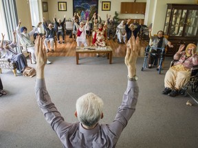 Residents take part in a sitting yoga class at the Guru Nanak Niwas senior home in Surrey.