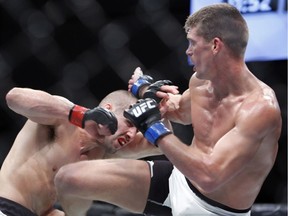 Stephen Thompson, right, of Simpsonville, S.C., connects with a kick to the body of Rory MacDonald during a Welterweight bout at UFC Fight Night Saturday in Ottawa. — The Canadian Press