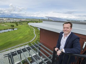 Realtor Mark Wiens admires the view from the rooftop deck of a luxury condo at 5055 Springs Blvd. in Tsawwassen on Thursday. Gerry Kahrmann/PNG