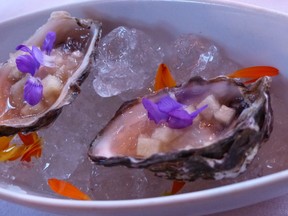 Fresh local oysters on the half-shell and dusted with edible flowers at Sooke Harbour House in Sooke,
