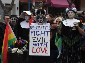 Participants show their support for victims of the Orlando shooting during the 2016 Gay Pride Parade on June 12, 2016 in Los Angeles, California.