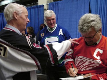 Mr. Hockey Gordie Howe (left) and Pat Quinn give Marcel Dionne (right) a hard time as he signs an autograph before they go out onto the ice at the Coliseum for Howe's 80th birthday party.