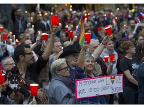 People take part in a candlelight vigil Sunday outside the Vancouver Art Gallery.