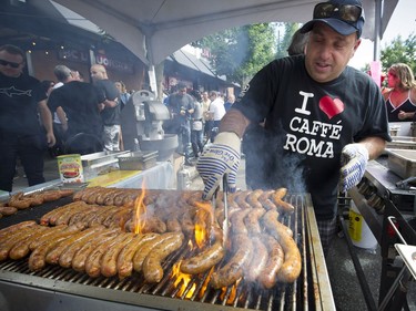 Italian Day on Vancouver's  Commercial Drive on June 12, 2016. Here, a chef grills Italian sausages.