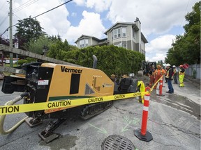 Crews prepare to lay fibreoptic cable in a lane behind Columbia St. between Debeck and Cumberland in New Westminster.