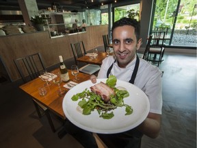 Chef Faizal Kassam holds a dish of crispy pork with smoked cauliflower and lentils at Terroir Kitchen in West Vancouver.