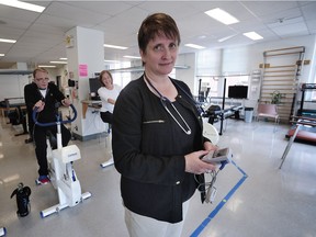 Pat Camp, head of St. Paul's Hospital Pulmonary Rehabilitation Clinic in Vancouver, teaches people with lung diseases how to do exercises that help them breathe more efficiently. Background, left to right: Randy Clyne and Barbara Deglau.
