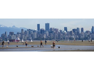 Beachgoers enjoy a low tide day in Vancouver, B.C., Sunday, June 5, 2016.