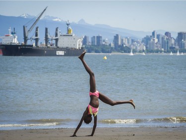 Cynthia Ouchi cartwheels on Spanish Banks beach in Vancouver, B.C., Sunday, June 5, 2016.