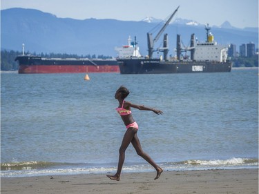 Cynthia Ouchi runs along Spanish Banks beach in Vancouver, B.C., Sunday, June 5, 2016.