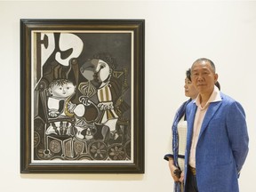 Qingxiang Guo, curator of the Wanda Group's Picasso collection, with his wife Bing Zhang next to the Claude et Paloma painting at the Vancouver Art Gallery in Vancouver, June 7, 2016.