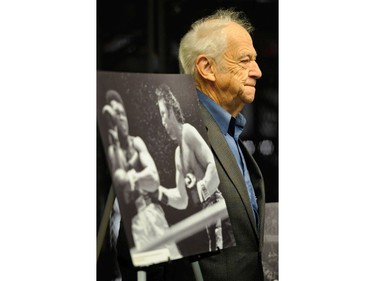 Former Vancouver Sun Ralph Bower poses November 10, 2011 with a photograph of Muhammad Ali and George Chuvalo made at the Pacific Coliseum in Vancouver, B.C. in 1972.
