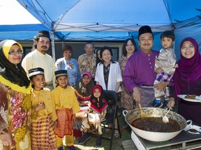 In this July 2015 photo, Mohd Adli Bin Abdullah (in purple) and his wife Intan Zurina Dollah (also in purple) prepare for the feast celebrating the end of Ramadan called the iftar with member of the Malaysian community in Vancouver.