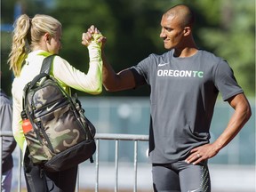 Brianne Theisen-Eaton high fives her husband Ashton Eaton prior to competing in the Vancouver Sun Harry Jerome International Track Classic at Swangard stadium.