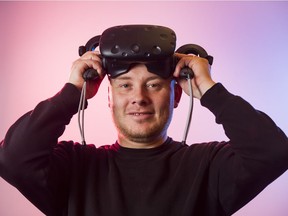 Hammer & Tusk founder Mack Flavelle wears a VR headset at Hammer & Tusk's virtual reality and interactive media studio on Vancouver June 23, 2016. Hammer & Tusk was purchased by digital studio Axiom Zen for $1 million in February.