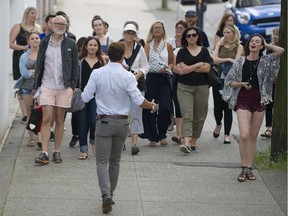 Luke Sykes (with back to camera) and Darby Steeves, right, are followed by the audience through the streets of Gastown in Surreal.