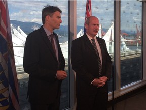 The government of B.C. will establish the legislative framework to allow the City of Vancouver to implement its proposed vacancy tax, B.C. finance minister Mike de Jong said Monday. Vancouver Mayor Gregor Robertson (left) and de Jong are shown in a file photo.