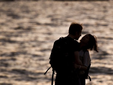 A couple embraces along the shores of Kits Beach in Vancouver, B.C., June, 4, 2016.