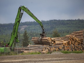 West Fraser Timber loading logs outside Quesnel River Pulp Co.