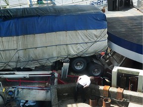 A truck sits stuck on a B.C. Ferries loading ramp, forcing the cancellation of several of the days sailings between Horseshoe Bay and destinations on Vancouver Island and the Sunshine Coast at the Horseshoe Bay ferry terminal in West Vancouver on Sunday.